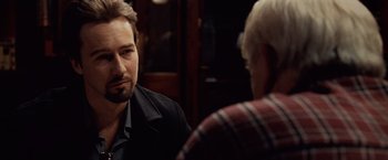 Movie still from “25th Hour” (2002), directed by Spike Lee – A man sitting in front of another man in front of a mirror; Close Up shot, Over the shoulder angle