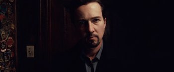 Movie still from “25th Hour” (2002), directed by Spike Lee – A person wearing a suit and tie; Close Up shot, Low angle