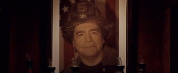 Movie still from “25th Hour” (2002), directed by Spike Lee – A picture of a man wearing a fireman's hat; Close Up shot, High angle