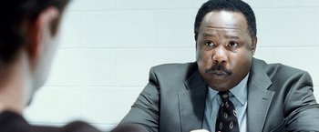 Movie still from “25th Hour” (2002), directed by Spike Lee – A man in a suit and a tie; Close Up shot, Over the shoulder angle