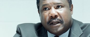 Movie still from “25th Hour” (2002), directed by Spike Lee – A person wearing a suit and tie; Close Up shot, Over the shoulder angle