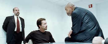 Movie still from “25th Hour” (2002), directed by Spike Lee – Two men sitting at a table talking to each other; Medium shot, Over the shoulder angle