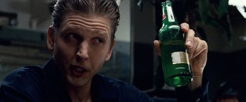 Movie still from “25th Hour” (2002), directed by Spike Lee – A person holding a bottle of beer; Close Up shot, Low angle