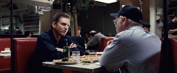 Movie still from “25th Hour” (2002), directed by Spike Lee – Two men are sitting at a table in a restaurant; Close Up shot, Over the shoulder angle