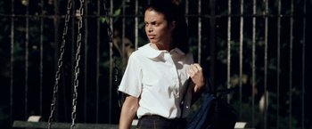 Movie still from “25th Hour” (2002), directed by Spike Lee – A woman in a white shirt is standing outside; Medium shot, Low angle