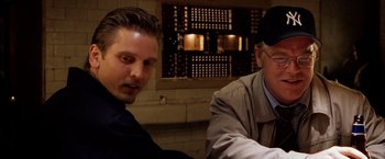 Movie still from “25th Hour” (2002), directed by Spike Lee – Two men sitting in front of each other in a room; Close Up shot, Over the shoulder angle