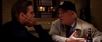 Movie still from “25th Hour” (2002), directed by Spike Lee – Two men sitting at a table talking to each other; Close Up shot, Over the shoulder angle