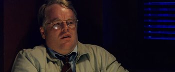 Movie still from “25th Hour” (2002), directed by Spike Lee – A person wearing glasses and a tie; Close Up shot, Over the shoulder angle