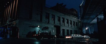Movie still from “25th Hour” (2002), directed by Spike Lee – A man riding a motorcycle down a street at night; Extreme Wide shot, High angle