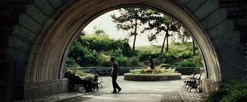 Movie still from “25th Hour” (2002), directed by Spike Lee – A man is walking in a park with a dog; Wide shot, Over the shoulder angle