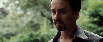 Movie still from “25th Hour” (2002), directed by Spike Lee – A person with a beard looking to his left; Close Up shot, Over the shoulder angle