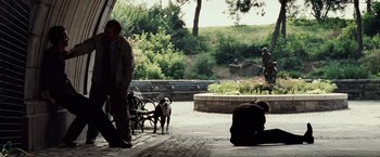 Movie still from “25th Hour” (2002), directed by Spike Lee – Two people and a dog in a park; Wide shot, Over the shoulder angle