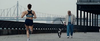 Movie still from “25th Hour” (2002), directed by Spike Lee – A man and a woman walking a dog on a city street; Wide shot, Over the shoulder angle