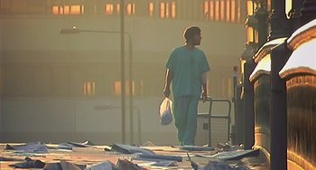 Movie still from “28 Days Later” (2002), directed by Danny Boyle – A man in scrubs walking down the street; Wide shot, Low angle