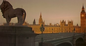 Movie still from “28 Days Later” (2002), directed by Danny Boyle – A view of a large building from across a bridge; Extreme Wide shot, Low angle