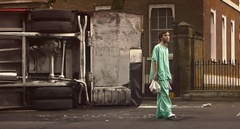 Movie still from “28 Days Later” (2002), directed by Danny Boyle – A man in scrubs walking down the street; Wide shot, Low angle