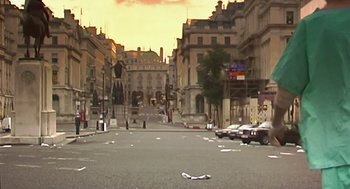Movie still from “28 Days Later” (2002), directed by Danny Boyle – A city street filled with lots of parked cars; Extreme Wide shot, High angle