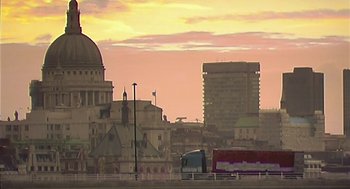 Movie still from “28 Days Later” (2002), directed by Danny Boyle – A view of a city skyline at sunset; Extreme Wide shot, Low angle