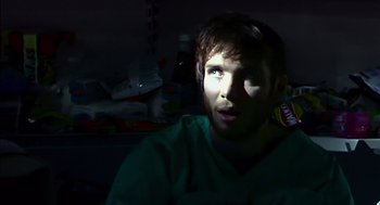 Movie still from “28 Days Later” (2002), directed by Danny Boyle – A man with a beard is looking at the camera; Close Up shot, Over the shoulder angle
