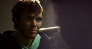 Movie still from “28 Days Later” (2002), directed by Danny Boyle – A person with a microphone; Close Up shot, Over the shoulder angle