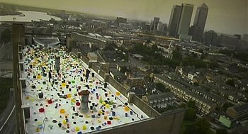 Movie still from “28 Days Later” (2002), directed by Danny Boyle – An aerial view of a city with a lot of balloons on the ground; Extreme Wide shot, High angle