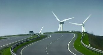 Movie still from “28 Days Later” (2002), directed by Danny Boyle – A road with wind turbines in the background; Extreme Wide shot, Low angle