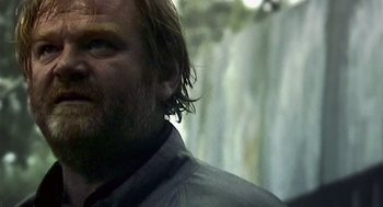 Movie still from “28 Days Later” (2002), directed by Danny Boyle – A man's face with a waterfall in the background; Close Up shot, Low angle