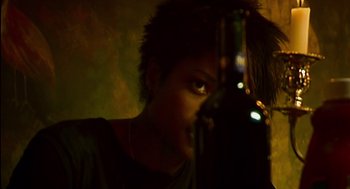 Movie still from “28 Days Later” (2002), directed by Danny Boyle – A young man holding a bottle of alcohol; Close Up shot, High angle