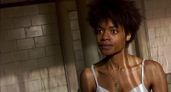 Movie still from “28 Days Later” (2002), directed by Danny Boyle – A person wearing a necklace; Close Up shot, Low angle