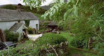Movie still from “28 Days Later” (2002), directed by Danny Boyle – An outdoor area with a shed and a hammock; Extreme Wide shot, High angle