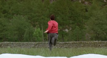Movie still from “28 Days Later” (2002), directed by Danny Boyle – A man running through a field with a frisbee; Wide shot, High angle