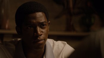 Movie still from “Snowfall” (2017), directed by Hiro Murai – A person wearing a white shirt; Close Up shot, Over the shoulder angle