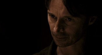 Movie still from “28 Weeks Later” (2007), directed by Juan Carlos Fresnadillo – A person looking at the camera; Close Up shot, Over the shoulder angle