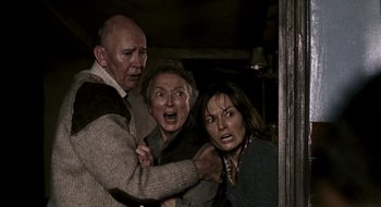 Movie still from “28 Weeks Later” (2007), directed by Juan Carlos Fresnadillo – A man and two women are in a room; Medium shot, High angle