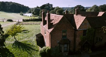 Movie still from “28 Weeks Later” (2007), directed by Juan Carlos Fresnadillo – An aerial view of an old brick house; Extreme Wide shot, High angle