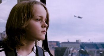 Movie still from “28 Weeks Later” (2007), directed by Juan Carlos Fresnadillo – A young girl looking out a window at an airplane; Close Up shot, Low angle