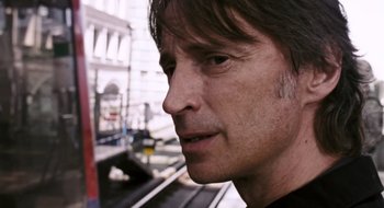 Movie still from “28 Weeks Later” (2007), directed by Juan Carlos Fresnadillo – A man's face in front of a building; Close Up shot, Low angle