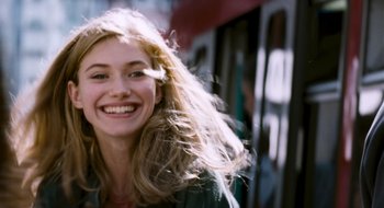 Movie still from “28 Weeks Later” (2007), directed by Juan Carlos Fresnadillo – A beautiful young lady smiling for the camera; Close Up shot, Low angle