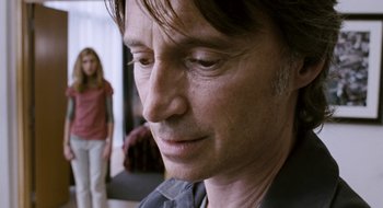 Movie still from “28 Weeks Later” (2007), directed by Juan Carlos Fresnadillo – A man's face as a woman looks on; Close Up shot, Over the shoulder angle