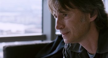 Movie still from “28 Weeks Later” (2007), directed by Juan Carlos Fresnadillo – A person sitting in front of a window; Close Up shot, Over the shoulder angle
