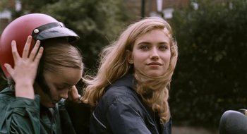 Movie still from “28 Weeks Later” (2007), directed by Juan Carlos Fresnadillo – Two young women standing next to each other on a sidewalk; Close Up shot, Over the shoulder angle