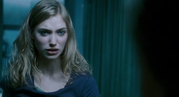 Movie still from “28 Weeks Later” (2007), directed by Juan Carlos Fresnadillo – A beautiful young woman with long , blonde hair; Close Up shot, Over the shoulder angle