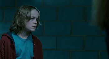 Movie still from “28 Weeks Later” (2007), directed by Juan Carlos Fresnadillo – A young girl is standing in front of a brick wall; Close Up shot, Low angle