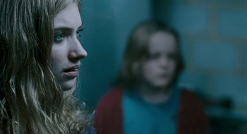 Movie still from “28 Weeks Later” (2007), directed by Juan Carlos Fresnadillo – Two young girls are looking at the camera; Close Up shot, Over the shoulder angle