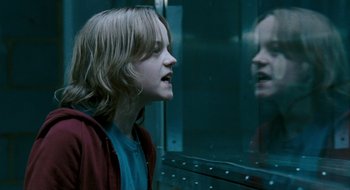 Movie still from “28 Weeks Later” (2007), directed by Juan Carlos Fresnadillo – A young man looking into a mirror in front of a train window; Close Up shot, Over the shoulder angle