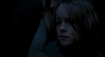 Movie still from “28 Weeks Later” (2007), directed by Juan Carlos Fresnadillo – A young girl with a bruised face sitting next to a woman; Close Up shot, High angle
