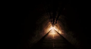 Movie still from “28 Weeks Later” (2007), directed by Juan Carlos Fresnadillo – A dark tunnel with a light at the end of the tunnel; Extreme Wide shot, High angle
