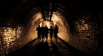 Movie still from “28 Weeks Later” (2007), directed by Juan Carlos Fresnadillo – A group of people are walking in a tunnel; Wide shot, Low angle