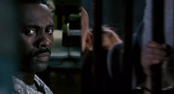 Movie still from “28 Weeks Later” (2007), directed by Juan Carlos Fresnadillo – A person behind a fence; Close Up shot, Over the shoulder angle