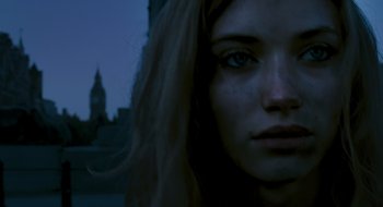Movie still from “28 Weeks Later” (2007), directed by Juan Carlos Fresnadillo – A woman's face in front of a clock tower; Close Up shot, Low angle